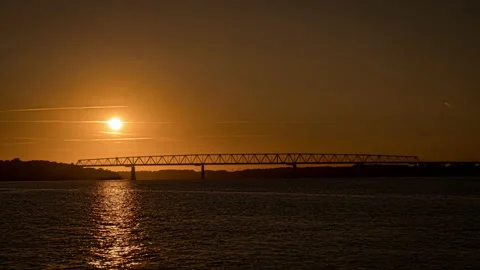 Sun setting through the Old Little Belt Bridge in Denmark Stock Footage 212304483