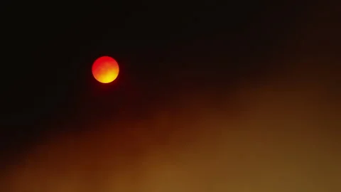 Sun Setting Through Smoke from Wild Fire Appearing as a Red Ball Stock Footage 137624845