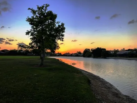 Sun setting into the water Stock Photos