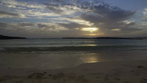 The sun is setting as the waves crash on the shore Video stock 127195408