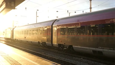 Sun setting while Railjet bound for Salzburg leaving Wels main station Stockbeeldmateriaal 219254837
