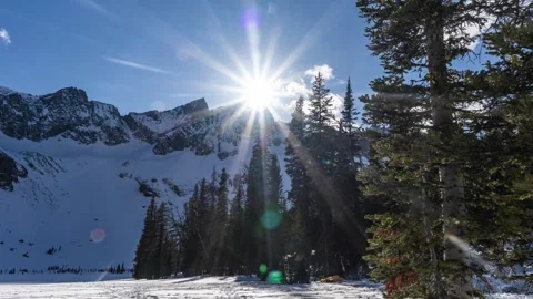 Sun setting on winter mountains, pack up tent Stock Footage 310563981