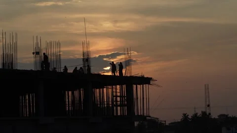 The sun is setting, yet the workers are continuing to work. Video stock 342204503