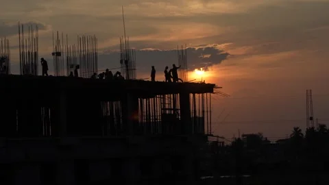 The sun is setting, yet the workers are continuing to work. Video stock 342204668