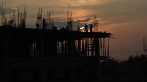The sun is setting, yet the workers are continuing to work. Video stock 342205073