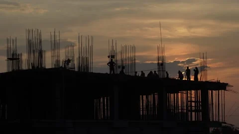 The sun is setting, yet the workers are continuing to work. Video stock 342205165