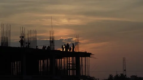 The sun is setting, yet the workers are continuing to work. Stock Footage 342702680