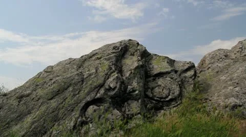 Sun shine over ancient rock symbol Stock Footage 20977060