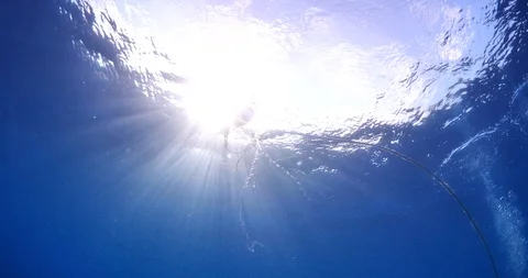 Sun shine sun beams and rays scuba divers underwater Video stock 104718688