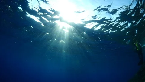 Sun shine sun beams and rays scuba divers underwater Video stock 105206397