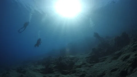 Sun shine sun beams and rays scuba divers underwater Video stock 105224919