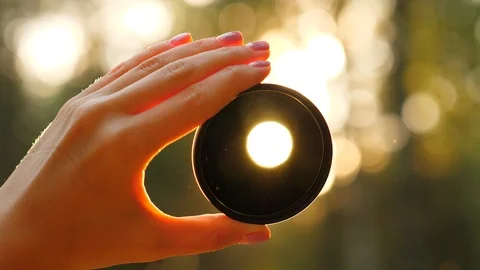 Sun shine through black lens, closeup Stock Footage 90898120