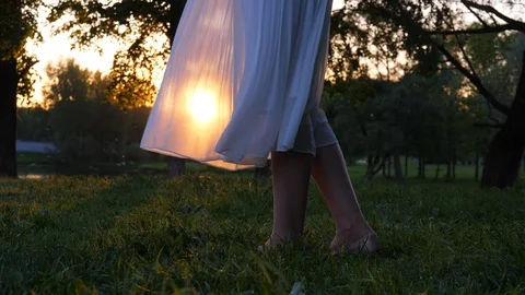 Sun shine through transparent white flying skirt, woman legs close up Stock Footage 90459165