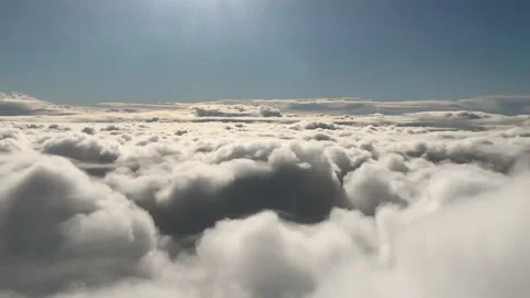 The sun shines above clouds blanketing the earth below Stock Footage 158651750