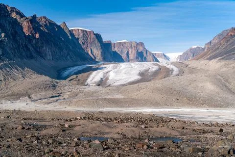 Sun shines above remote arctic valley of Akshayuk Pass, Baffin Island, Canada Stock Photos