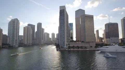 Sun shines between two tall buildings on MIami waterfront Stock Footage 84978721