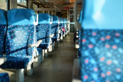 Sun shines on empty seats in train, abstract rail travel concept with shall.. Stock Photos