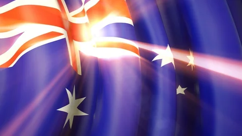 The sun shines with golden rays through the waving flag of australia. Australian Stock Footage 129926657