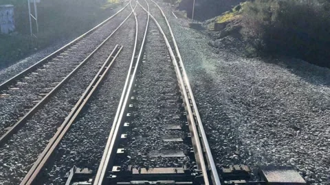 The sun shines on the moving train tracks Stock Footage 313220130
