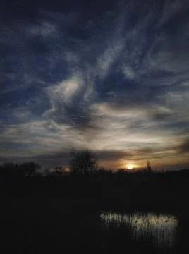 The sun shines over the river at dawn Stock Photos