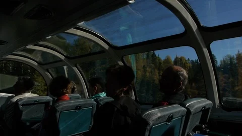 The Sun shines on Passengers in the Train Observation Car Stock Footage 92649944