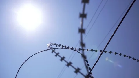 The sun shines through the barbed wire. Shooted in motion. Stock Footage 79622701