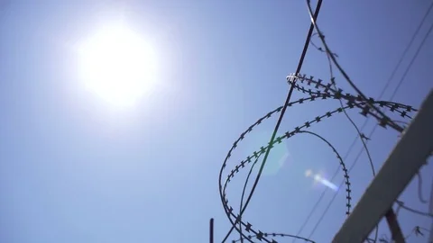 The sun shines through the barbed wire Stock Footage 79622767