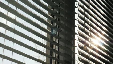The sun shines through the blinds on the window Stock Footage 141921076