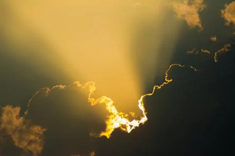Sun shines through the clouds and the sky shines in light Stock Photos