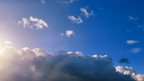 The sun shines through the clouds, creating a stunning display of light and.. Stock Photos