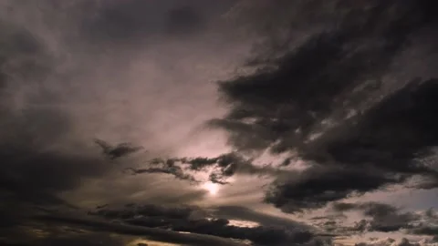 The sun shines through the clouds flying quickly. Stock Footage 142759285
