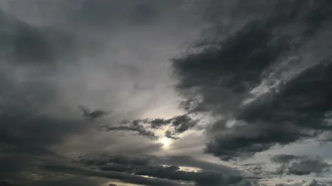 The sun shines through the clouds flying quickly. Stock Footage 142759341