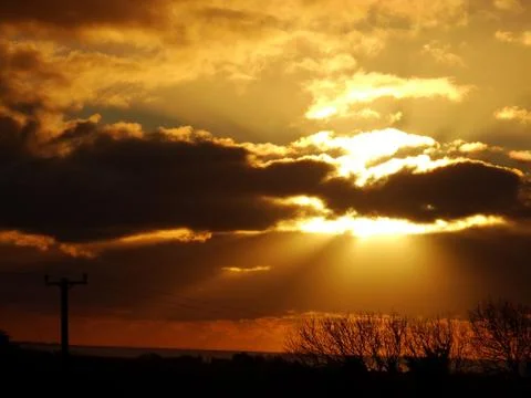 Sun shines through the clouds Stock Photos