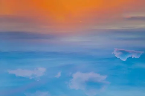 The sun shines through the clouds in the sunset sky with dramatic light. The Stock Photos