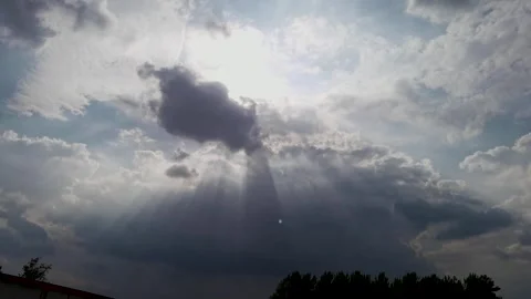 The sun shines through the dark clouds in the sky Stock Footage 247958455