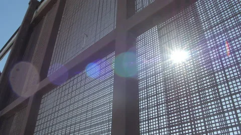 Sun Shines Through Fence on US and Mexico Border Stock Footage 60405672