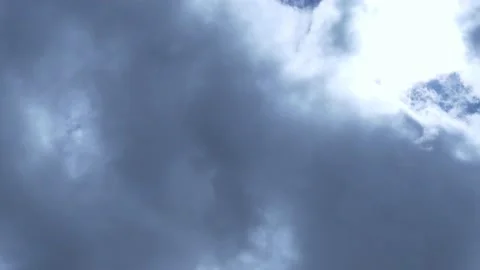 The Sun Shines Through The Gray Storm Clouds Floating across the Blue Sky Time L Stock Footage 151833696