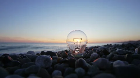 Sun shines through a light bulb Stock Footage 157017562