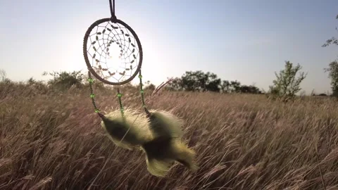 The sun shines through the mesh of the dream catcher. Stock Footage 257944004