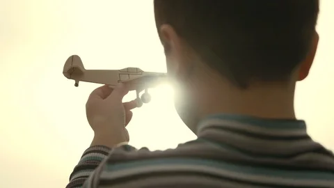 The sun shines through the model airplane in the boy's hand 스톡 동영상 88438678