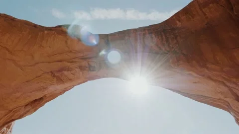 Sun Shines Through An Rock Arch Of Fiery Orange Colored In Arches National Park Stock Footage 151006855