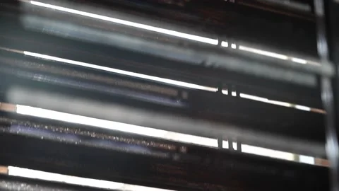 Sun shines through roller shutter going up until window is open completely Stock Footage 148242953