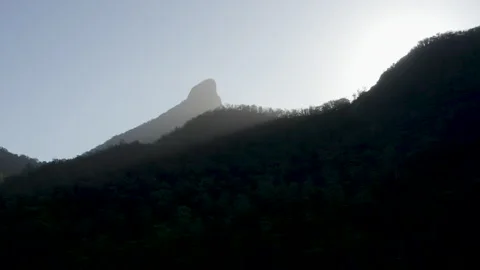 Sun shines through Sacred Summit in Wollumbin, Australia, QLD, Gondwana Stock Footage 236512618