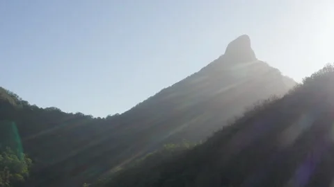 Sun shines through Sacred Summit in Wollumbin, Australia, QLD, Gondwana Stock Footage 236513126