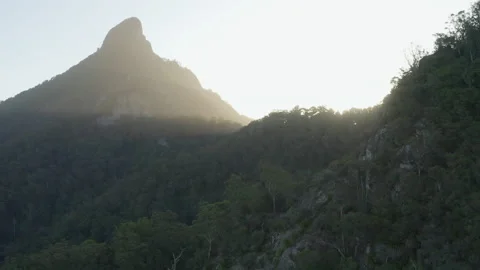 Sun shines through Sacred Summit, Wollumbin, Australia, QLD, Gondwana Stock Footage 236514751