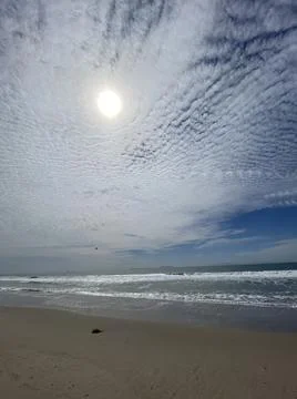 Sun shines through small clouds over Ventura Beach, California 写真素材
