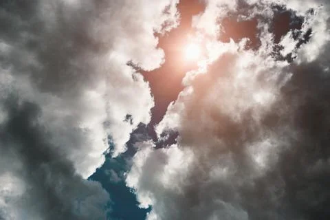Sun shines through storm clouds, dramatic sky scenery with thunderclouds up a Stock-Fotos