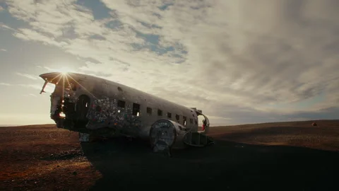 Sun shines through the window of a plainwreck, flair, entire plain, Iceland Stock Footage 260952766
