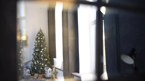The sun shines through the window of the room with a Christmas tree Stock Footage 120142684