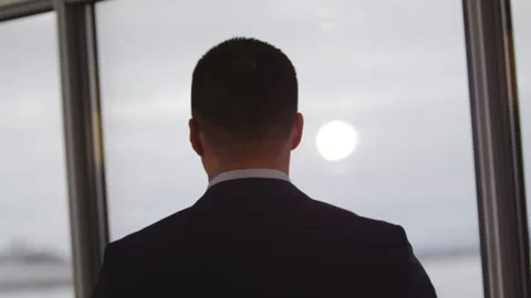 Sun shines on young man face standing near office window Stock Footage 243299112